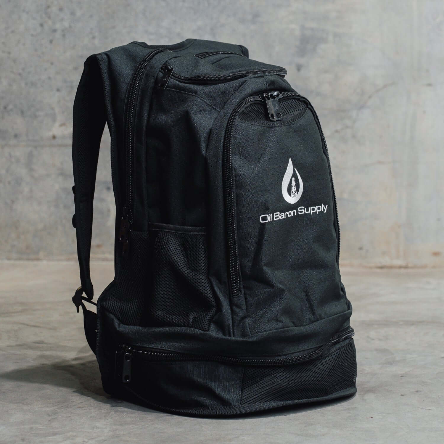 Black backpack with a logo on a gray background