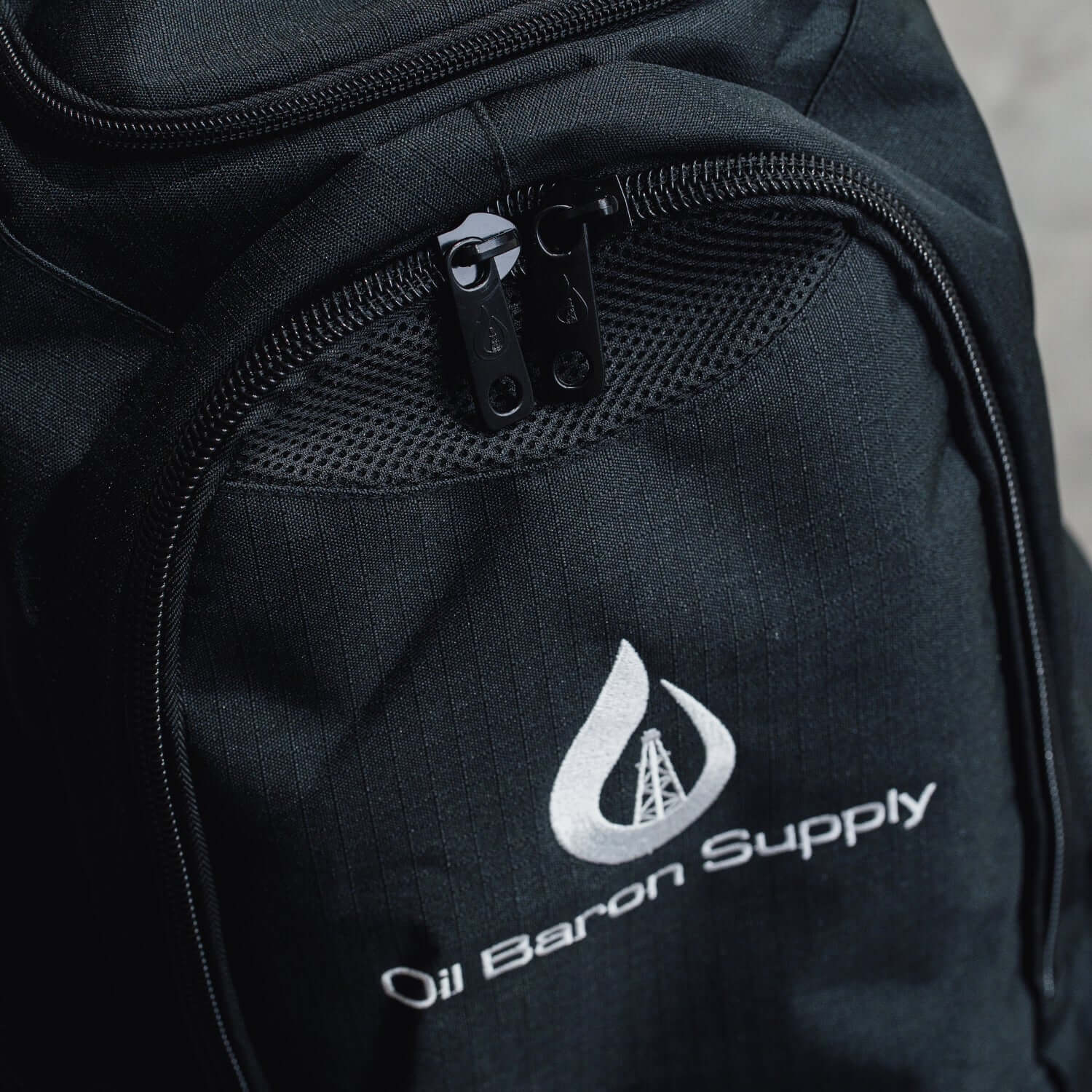 Black backpack with Oil Baron Supply logo on a neutral background
