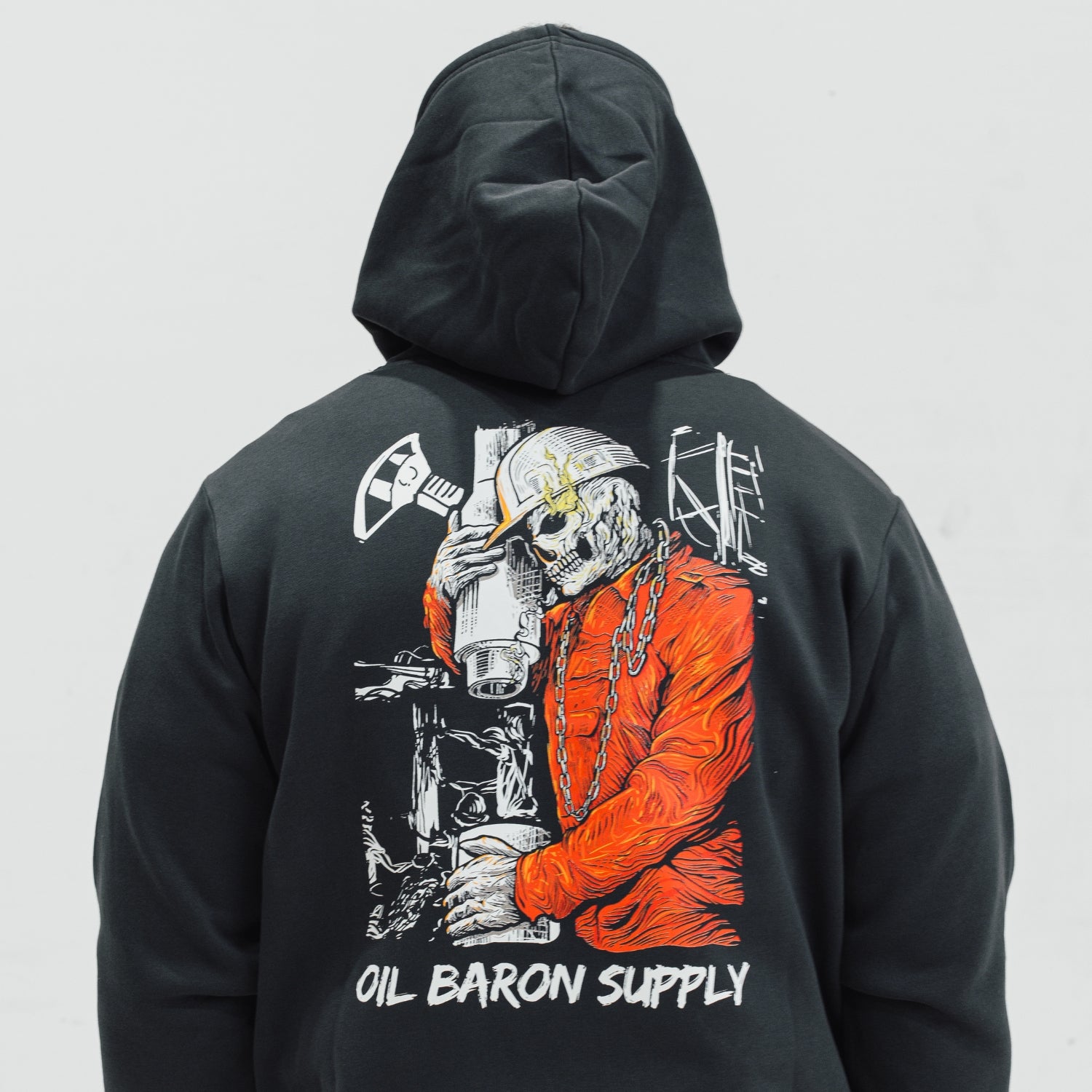 Black hoodie with a graphic design on the back, featuring a Roughneck skeleton in an orange coat and the text 'Oil Baron Supply'.